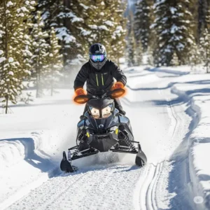 A person riding a snowmobile through a snowy trail, clearly wearing heated snowmobile gloves, demonstrating their use during an activity.