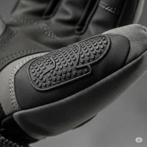 A close-up on the palm of a heated snowmobile glove, highlighting the reinforced, textured grip material for secure handling.