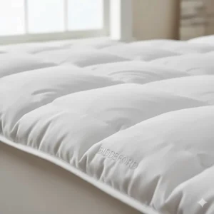 Detailed shot of the soft quilted polyester fabric and stitching of a Biddeford mattress topper.