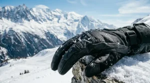 Water droplets beading off the surface of a durable leather and softshell heated glove designed for wet alpine conditions.