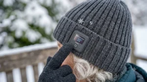 Close-up view of the easy-to-use temperature control button on a heated beanie for seniors.