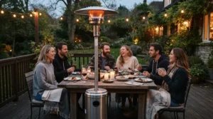 Guests enjoying a dinner party kept warm by the best outdoor propane heater on a wooden deck.