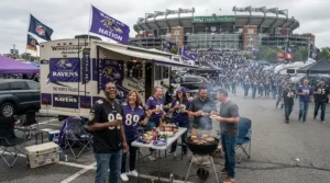 Tailgating fans staying warm before a football game using the best portable propane heater near an RV.
