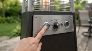 Close-up view of the simple control knob and electronic ignition on a dyna-glo patio heater.