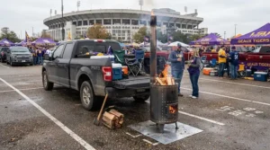 A portable pellet patio heater keeping sports fans warm during a stadium parking lot tailgate party